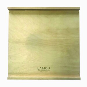 May include: A plain, light brown wooden board with a logo that reads "LAMOU'" and the website "www.lamoudesign.com". The logo is printed in black and the website is printed in a smaller font size.