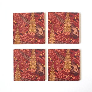 May include: Set of four square coasters with a repeating pattern of stylized birds, flowers, and leaves. The background is a deep red color, and the pattern is in shades of yellow and orange.