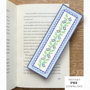May include: A rectangular bookmark with a floral design. The bookmark features a white background with a blue border and a central pattern of green leaves and yellow flowers. The text "INSTANT PDF DOWNLOAD" is visible.