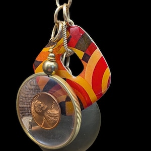 1975 Retro Pendant Necklace With 3 Chunky Charms On A Goldtone Chain Including A Locket, Funky Colored Square And Lucite Penney Charm  #1092