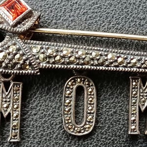 Judith Jack Sparkling Marcasites and a Garnet or Glass Stone Sterling Silver Brooch With Dangling Letters That Spell Out MOM. #273