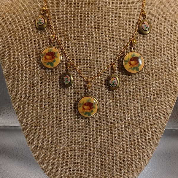 Lucy Isaacs NYC Goldtone Locket Necklace With 4 Small and 3 Large Lockets With Flowers Dangling From A Goldtone Chain #381