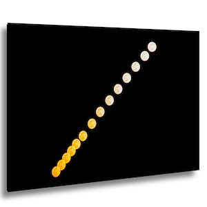 May include: A black canvas print featuring a diagonal line of moon phases, transitioning from yellow to white. The phases are evenly spaced, creating a visual representation of the lunar cycle. The background is solid black.