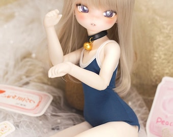May include: A doll with long blonde hair wearing a blue swimsuit with white trim and a gold bell collar.