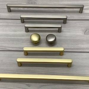 May include: Assortment of cabinet hardware in brushed nickel and gold finishes.  The hardware includes pulls in various sizes and knobs.