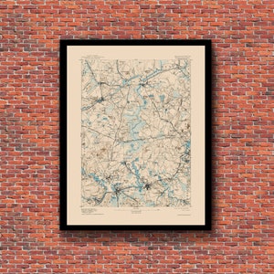 May include: A vintage map of Massachusetts, printed on cream-colored paper with blue and brown ink. The map shows the state's geography, including rivers, lakes, and towns. The title "MASSACHUSETTS" is printed at the top right corner of the map.