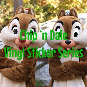 May include: Chip 'n Dale Vinyl Sticker Series featuring Chip and Dale, two cartoon squirrels, with their arms crossed. They are wearing brown fur costumes and have large, expressive eyes.