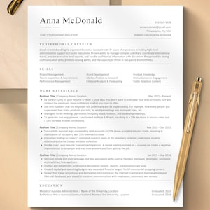 May include: A professional CV with the name "Anna McDonald" at the top. The CV includes sections for professional overview, skills, work experience, and education. The document is printed on white paper with a gold pen resting on the side.