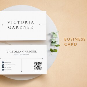 May include: A white business card with black text for Victoria Gardner, a medical professional. The card includes contact information, a QR code, and the text "THE STAND OUT RESUME".