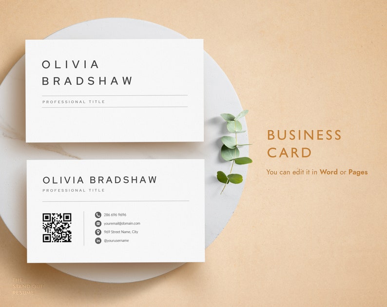 May include: A white business card with the name Olivia Bradshaw and a professional title. The card also includes a phone number, email address, street address, and social media handle. The card is on a white plate with a sprig of eucalyptus.