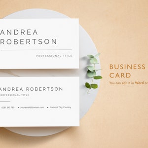May include: A white business card mockup with the name Andrea Robertson and the text "Professional Title". The card is on a white plate with a sprig of eucalyptus.