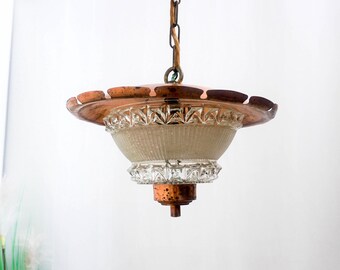 May include: A copper and glass pendant light fixture with a scalloped edge and a frosted glass shade.