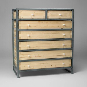May include: A six-drawer dresser with a metal frame and wooden drawers. The drawers have white knobs and the frame is a dark gray color.