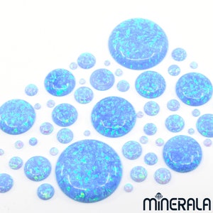 May include: Assortment of blue opal cabochons in various sizes. The cabochons are round and have a light blue colour with iridescent shimmer.