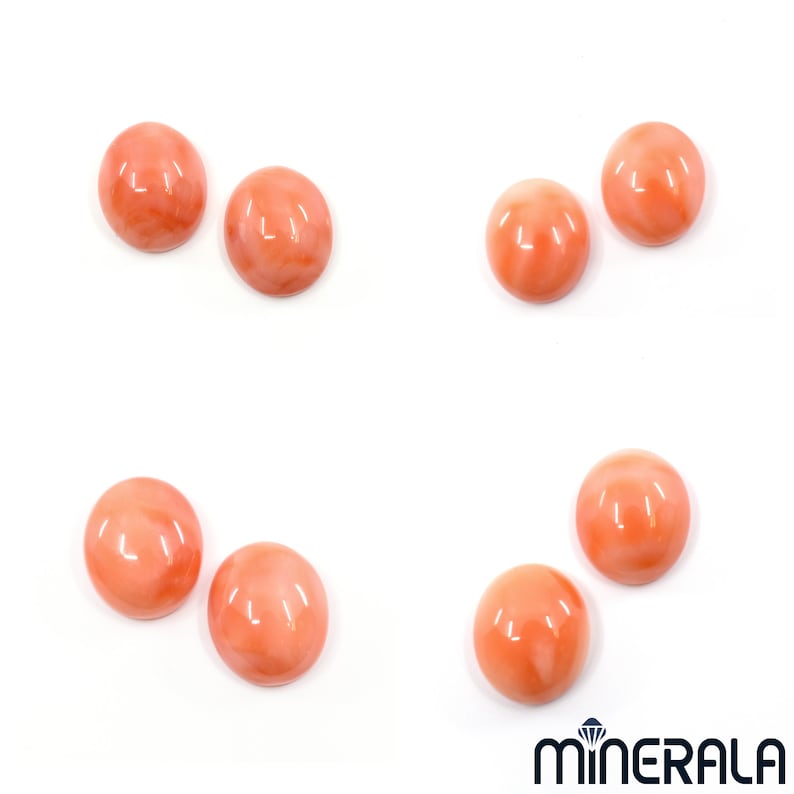May include: Seven round, smooth, coral cabochons in various shades of pink and orange. The cabochons are arranged in a circular pattern on a white background.