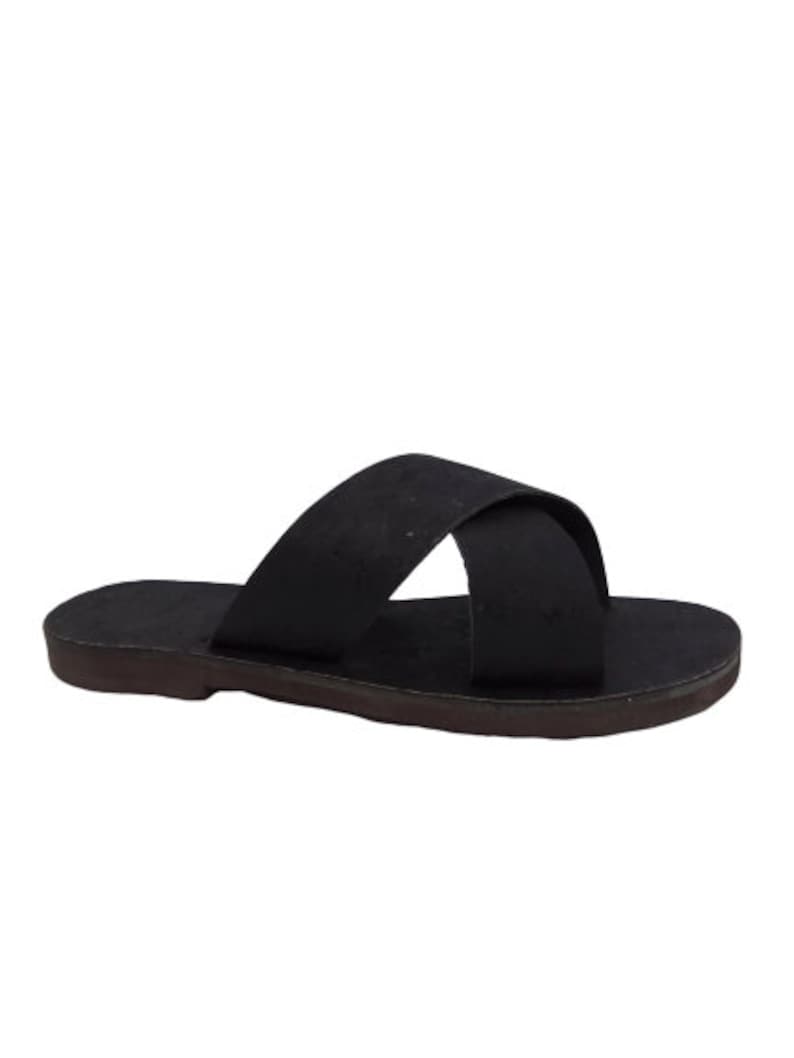 May include: Black leather sandals with a criss-cross strap design.