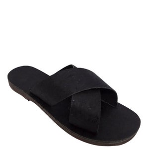 May include: Black leather sandals with a criss-cross strap design. The sandals have a flat sole and a cork-like texture.