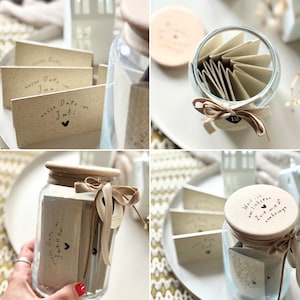 Könnte beinhalten: Eine Sammlung handgefertigter Geschenkgläser und Karten. Die Gläser sind aus klarem Glas mit Holzdeckeln, gebunden mit beigen Bändern. Die Karten sind beige mit handschriftlichem Text und kleinen Herzillustrationen. Ein Glas hat den Text "Weil ich am liebsten Zeit mit dir verbringe."