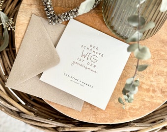 May include: A white card with the text "Der schönste Weg ist der gemeinsame."  Christine & Hannes 20. August 2023.