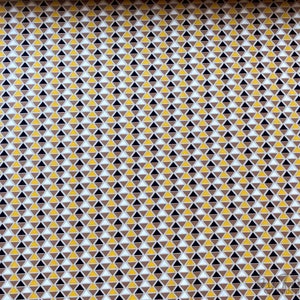 May include: A seamless fabric pattern with a repeating geometric design of small triangles in shades of brown, yellow, white, and black.