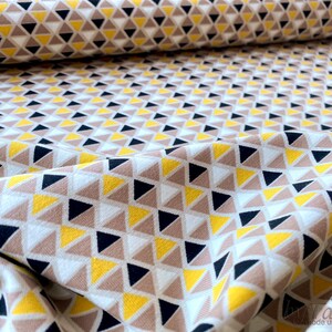 May include: White fabric with a geometric pattern of yellow, brown, and black triangles.