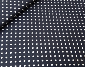 May include: Black fabric with a white polka dot pattern. The dots are evenly spaced and are a medium size.