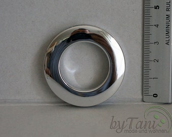 May include: A silver metal curtain ring with a 1-inch inner diameter. The ring is shown next to a ruler for size reference.