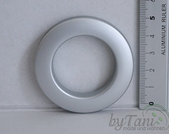 May include: A silver metal curtain ring with a 1-inch inner diameter. The ring is shown next to a ruler for size reference.