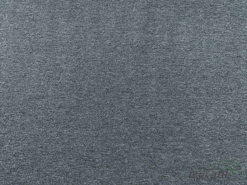 May include: A close-up of a dark gray textured fabric. The fabric has a subtle sheen and a slightly rough texture.