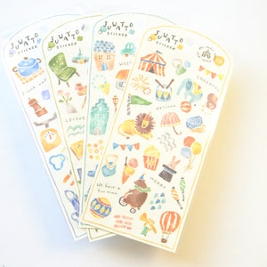May include: Four sticker sheets with watercolor illustrations. Each sheet features a different theme, including cooking, leisure, and a circus. Text includes "JUWATTO STICKER", "I cook well", "We have a fun time", and "Cheerful".