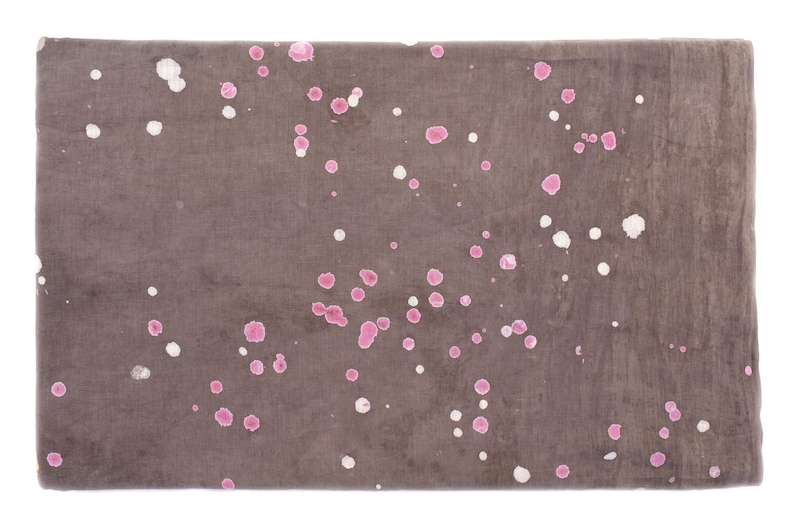 May include: A brown fabric with pink and white splatter paint. The fabric has a subtle texture.