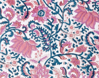 May include: A white fabric with a pink and blue floral pattern. The pattern features intricate designs of flowers, leaves, and swirls.