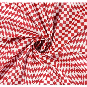 May include: Red and white checkered fabric with a diamond pattern. The fabric is folded and twisted, creating a swirling effect.