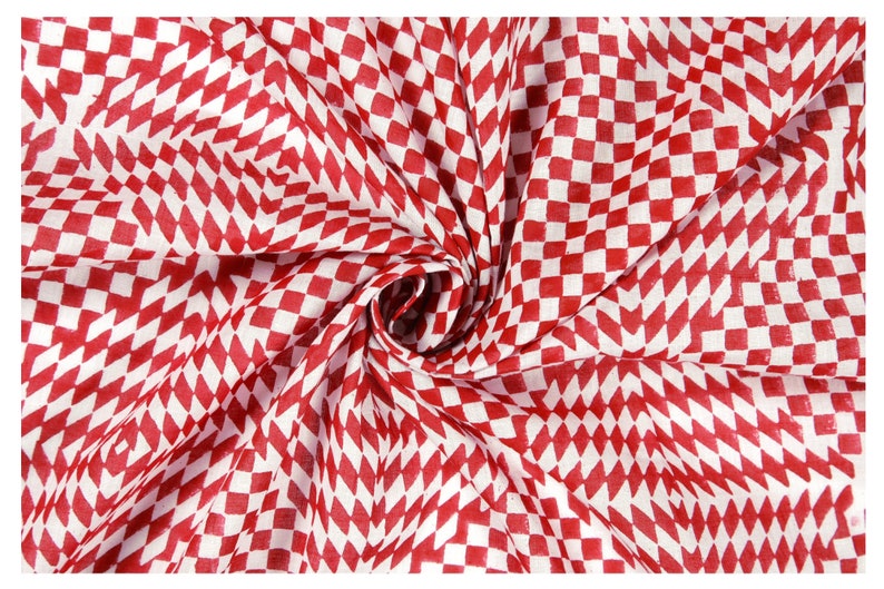 May include: Red and white checkered fabric with a diamond pattern. The fabric is folded and twisted, creating a swirling effect.