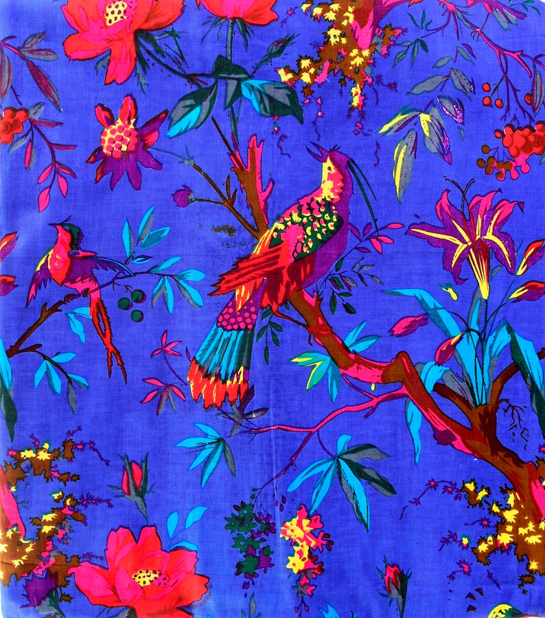 May include: A vibrant blue fabric with a floral and bird pattern. The design features pink flowers, green leaves, and red and blue birds.