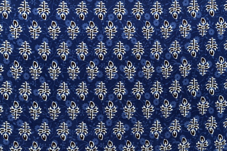 May include: A blue fabric with a white and black floral pattern. The pattern is a repeating design of small flowers and leaves.