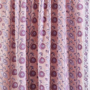 May include: Pink fabric with a floral pattern featuring purple flowers and leaves. The fabric has a subtle sheen and a soft texture.