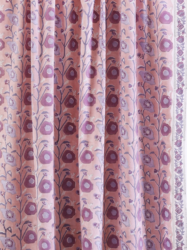 May include: Pink fabric with a floral pattern featuring purple flowers and leaves. The fabric has a subtle sheen and a soft texture.