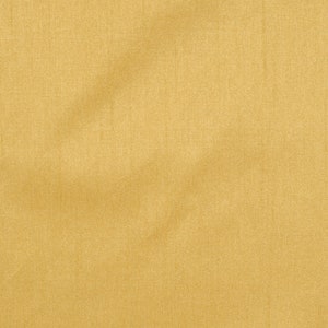 Puede incluir: Primer plano de una tela lisa de color amarillo dorado con una textura sutil. La tela tiene un ligero brillo y parece estar hecha de un material ligero.
