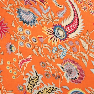 May include: Orange fabric with a floral pattern. The flowers are in shades of blue, red, yellow, and green. The fabric has a vintage feel.
