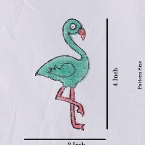 May include: A green flamingo with a pink beak and legs. The flamingo is standing on one leg and has its head tilted to the side. The flamingo is 4 inches tall and 2 inches wide.