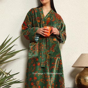May include: A green velvet robe with a floral print and a matching sash. The robe has a V-neck and long sleeves. This image &copy; TheBlockPrints
