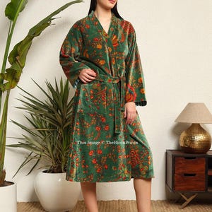 May include: A green velvet robe with a floral print and a tie belt. The robe has a long sleeve and a knee-length hem. This image &copy; TheBlockPrints