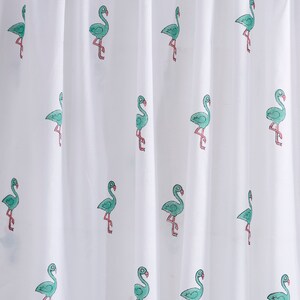 May include: White sheer shower curtain with a repeating pattern of green flamingos. The flamingos are outlined in pink and have a simple, cartoon-like design.