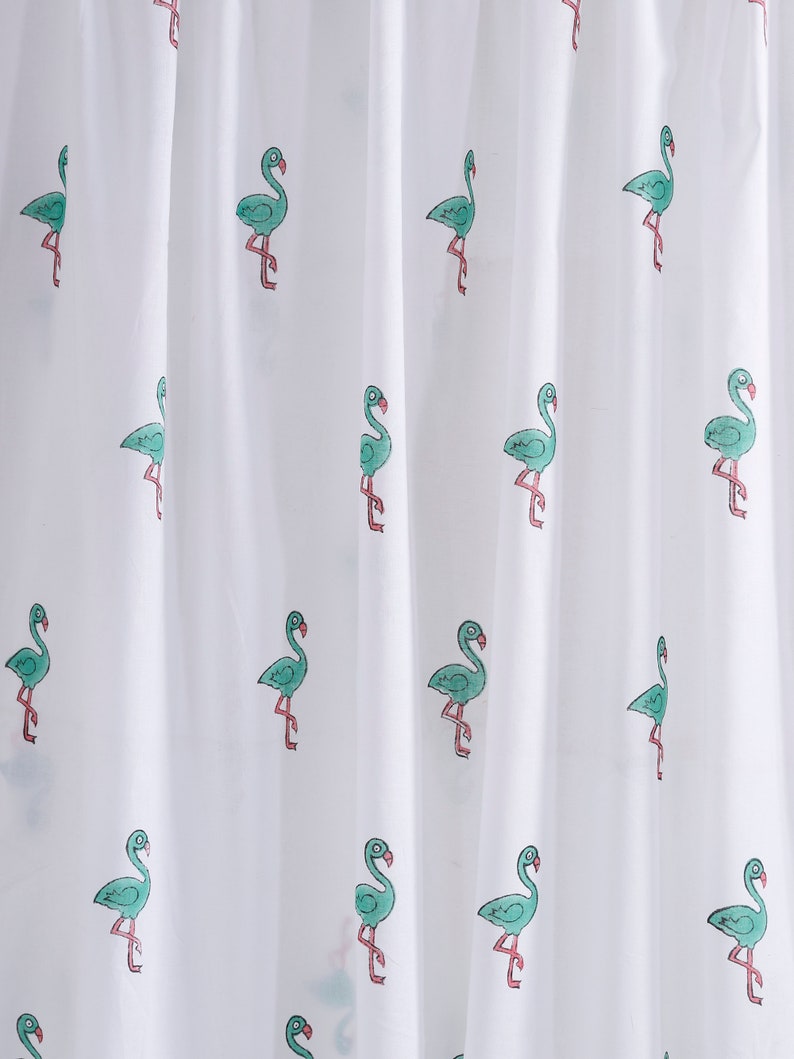 May include: White sheer shower curtain with a repeating pattern of green flamingos. The flamingos are outlined in pink and have a simple, cartoon-like design.