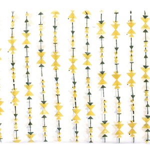 May include: A white background with a repeating pattern of yellow and green triangles. The triangles are arranged in vertical lines, creating a geometric design.