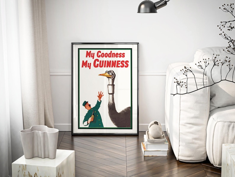 May include: Framed vintage Guinness advertisement featuring an ostrich and a man in a green uniform. The poster has the text "My Goodness My Guinness" in red and white. The artwork is displayed in a black frame.