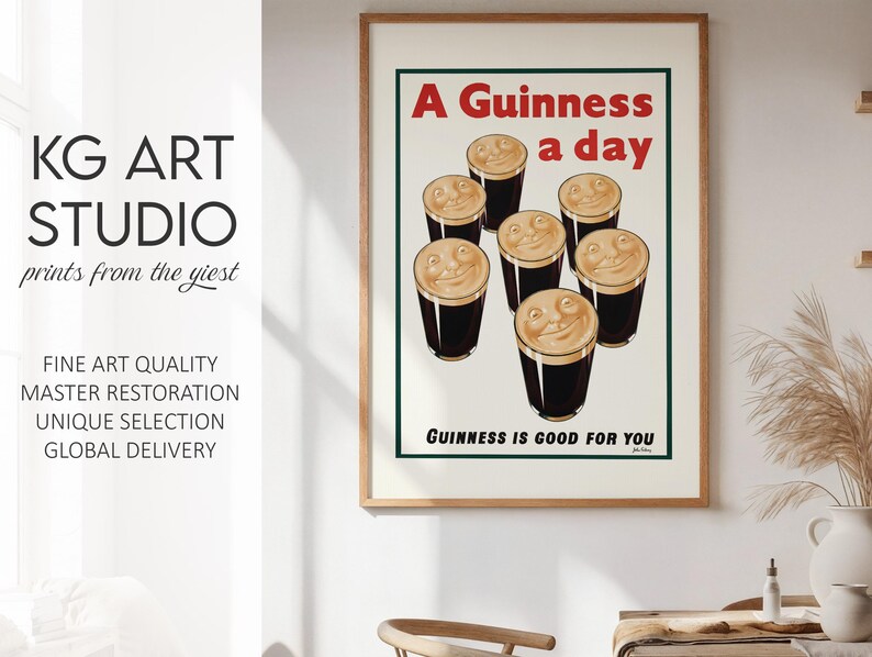 May include: A framed vintage Guinness advertisement poster. The poster features the text "A Guinness a day" in red, with smiling pints of Guinness. The text "Guinness is good for you" is at the bottom. The poster is in a wooden frame.