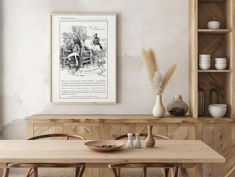 May include: Framed vintage black and white print featuring an illustration of two men in a rural setting. The print includes text and is displayed on a wooden table with decorative items. The room has a neutral color palette.