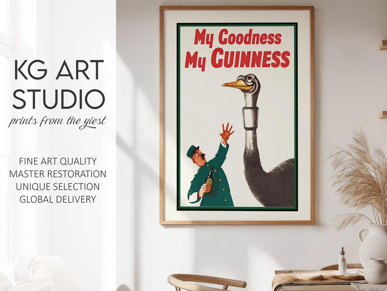 May include: Framed vintage Guinness advertisement featuring a cartoon of a man in a green uniform reaching up towards a large bird with a long neck. The text "My Goodness My Guinness" is in red. The artwork is from KG Art Studio.
